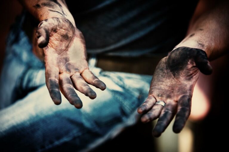 mechanic with dirty hands after fixing the brakes