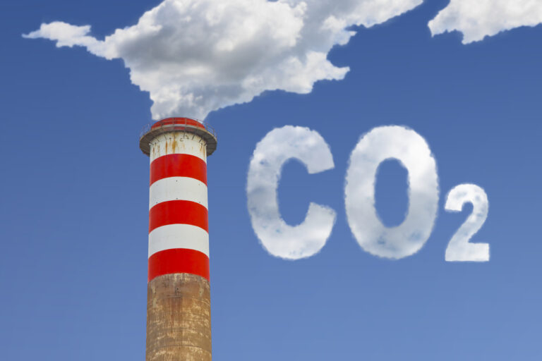 High concrete chimney emits CO2 into the atmosphere – concept im