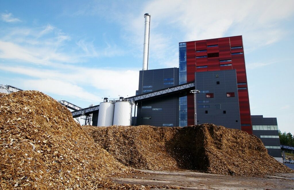 bio power plant with storage of wooden fuel (biomass) against bl