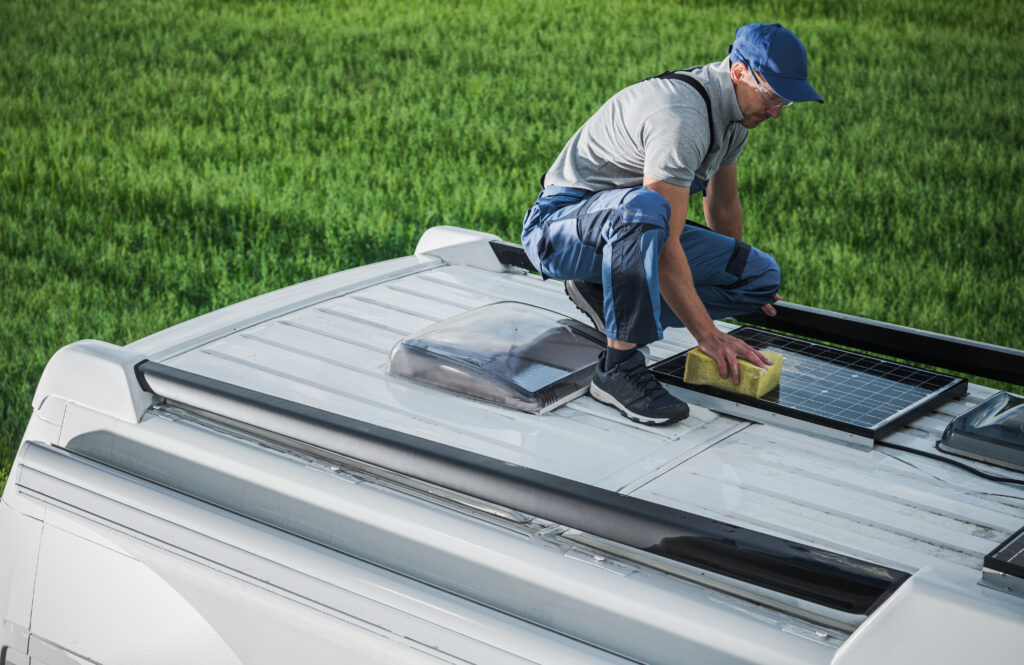 Men Cleaning Camper Van RV Roof Installed Solar Panels