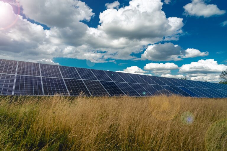 Solar panels and blue sky with clouds