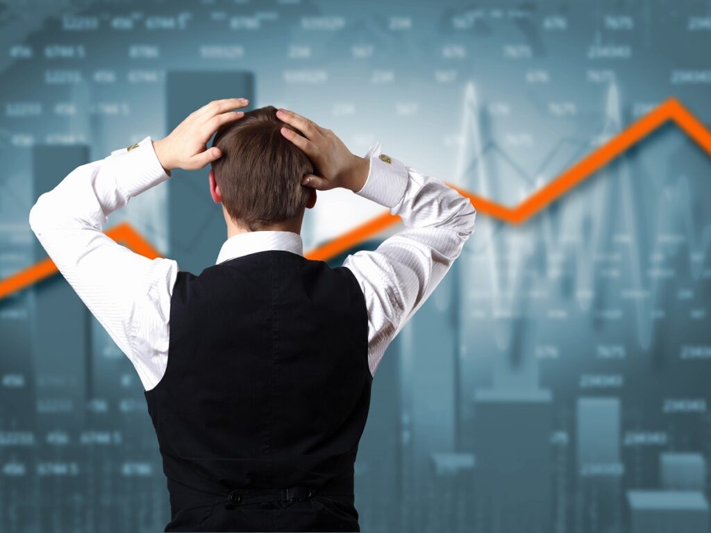 Young businessman against financial graphs