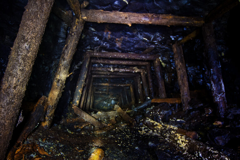 Abandoned mine with rotten wooden miner stands. Old derelict dev